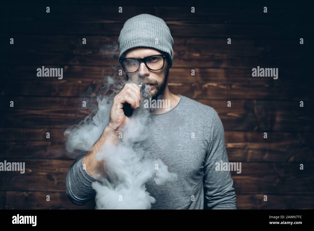 Vaping flavored e-liquid from an electronic cigarette Stock Photo