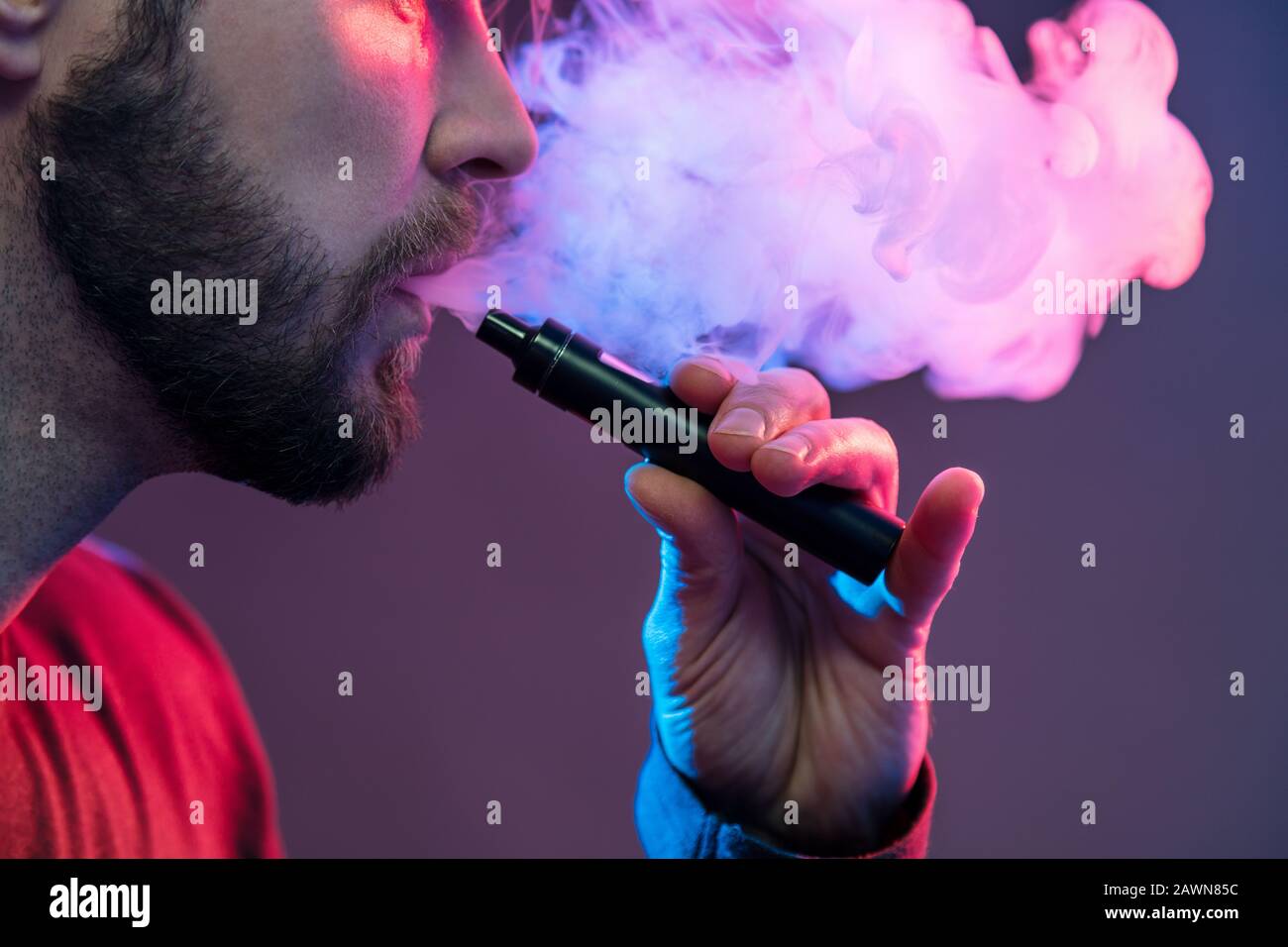 Vaping flavored e-liquid from an electronic cigarette Stock Photo