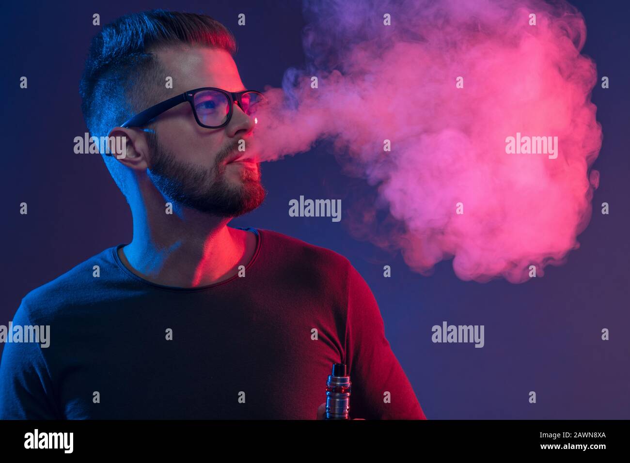 Vaping flavored e-liquid from an electronic cigarette Stock Photo