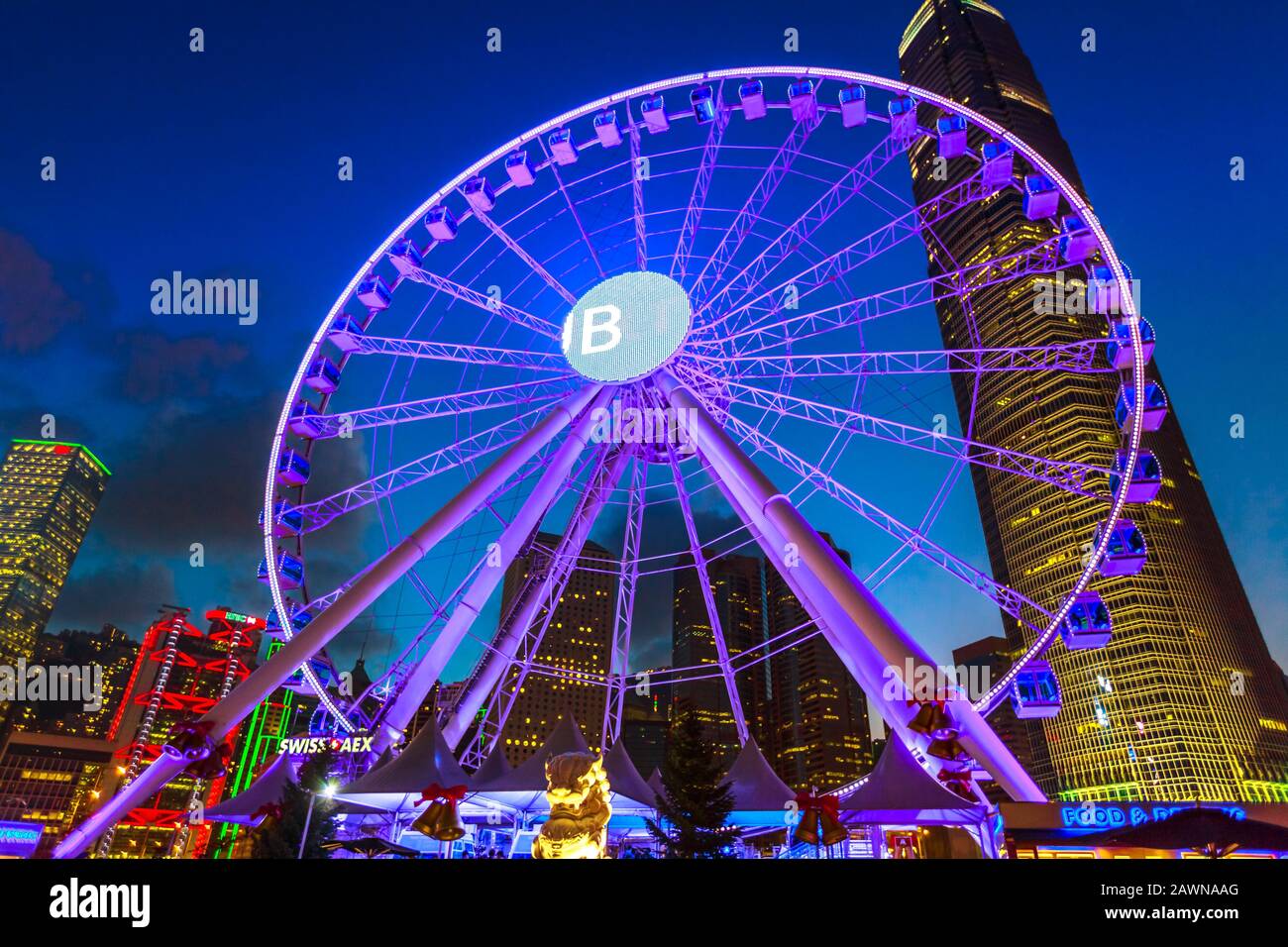 Hong Kong, China - December 11, 2016: the Observation Wheel of Hong Kong island at night near Ferry Pier area with landmark buildings and banks HQs in Stock Photo