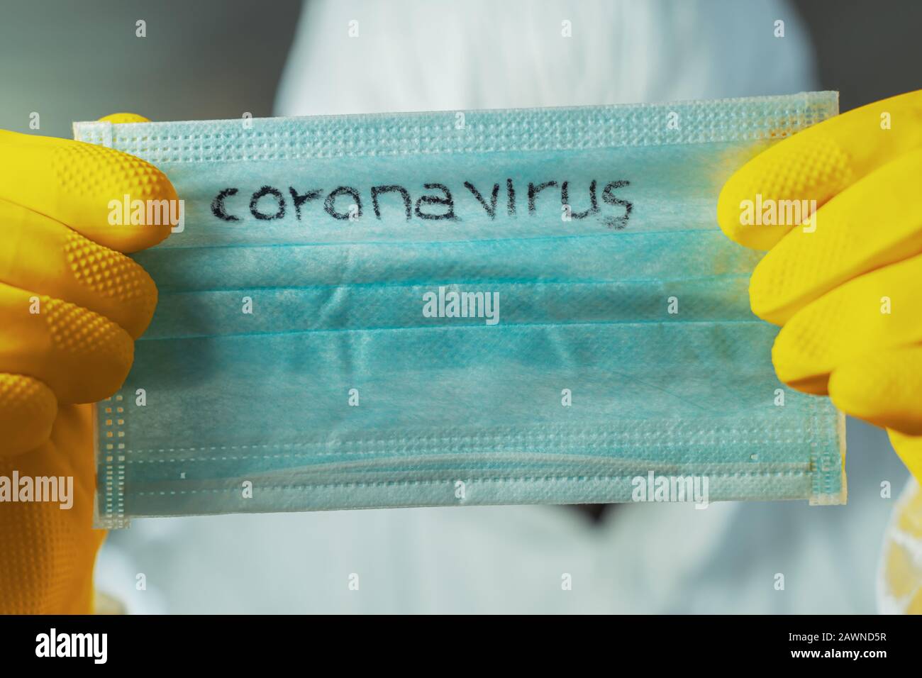 Epidemiologist holding Coronavirus respiratory mask, close up Stock Photo