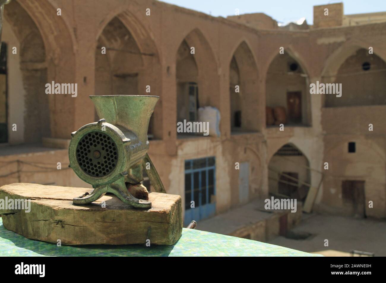 Wide angle shot of a metal grinder in front of a building Stock Photo