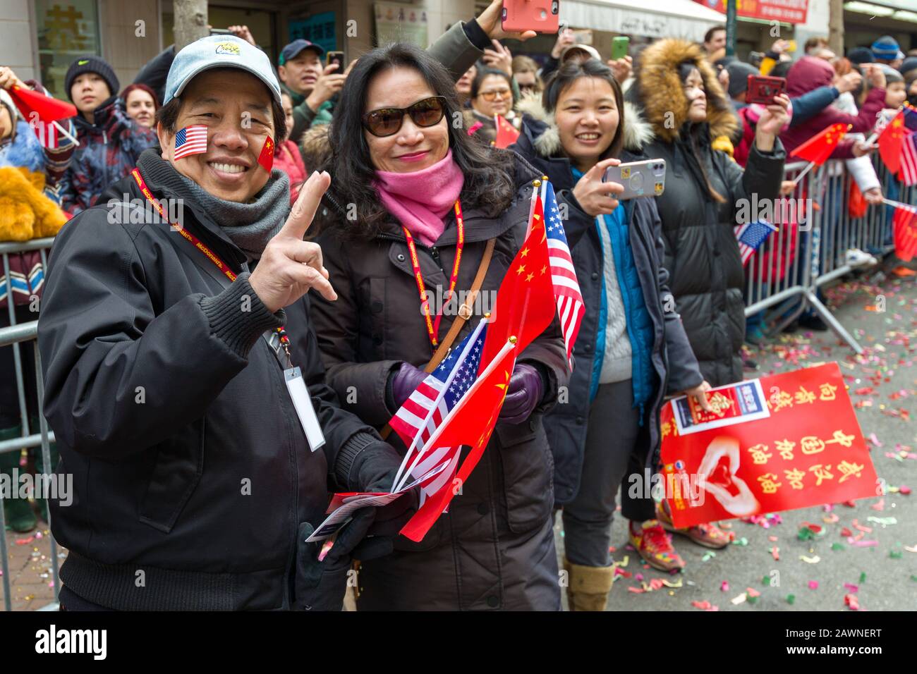New York, USA. 9th Feb, 2020. Participants wear US and Chinese flags as they participate in the Chinese New Year parade in Chinatown. Credit: Enrique Shore/Alamy Live News Stock Photo