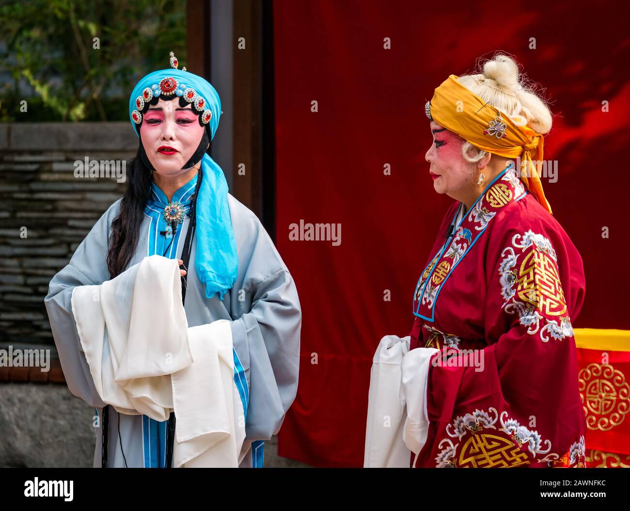 Men performing outdoor Peking opera in colourful costumes, Xi Cheng Hutong District, Beijing, China Stock Photo