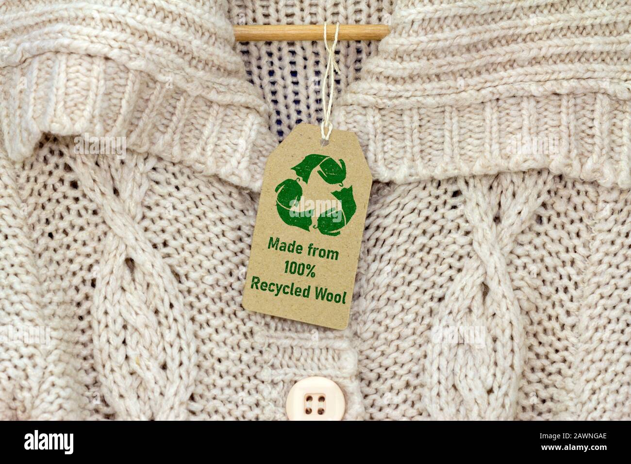 recycle wool text and recycle reuse symbol on wool jumper tag