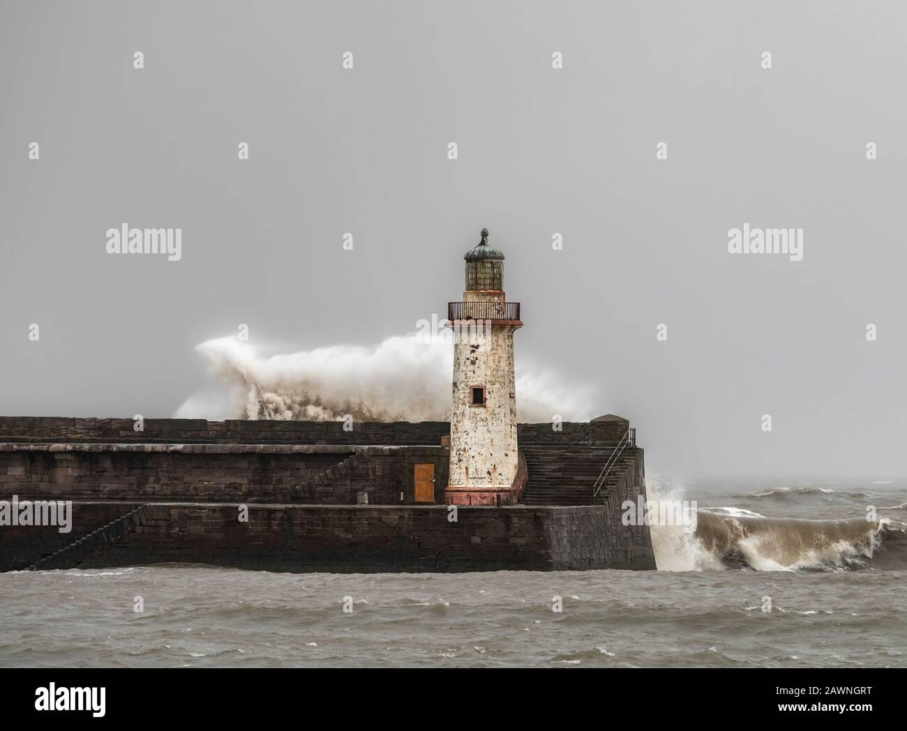 Storm Ciara battering a light house on the Cumbrian coast Stock Photo