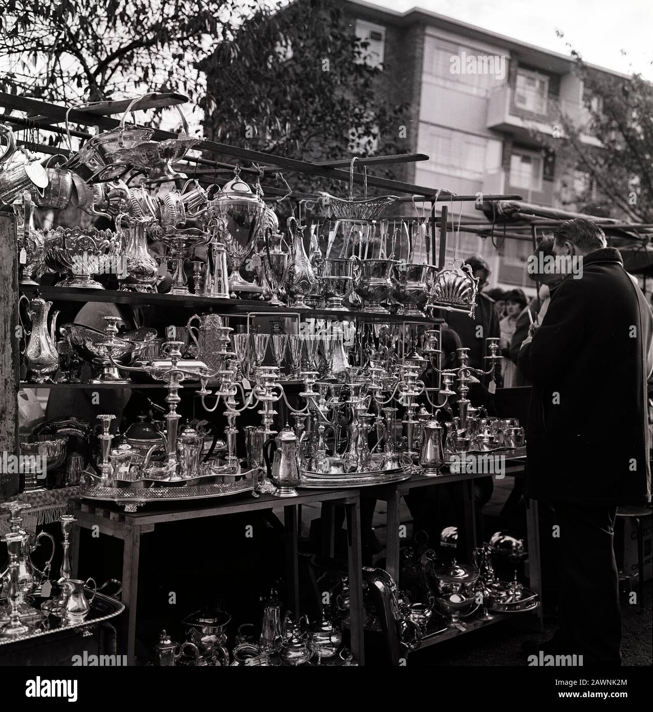 Nickel silver, Metalware, potts and pans at the market in Portobello Road in Notting Hill, London in the 60s Stock Photo