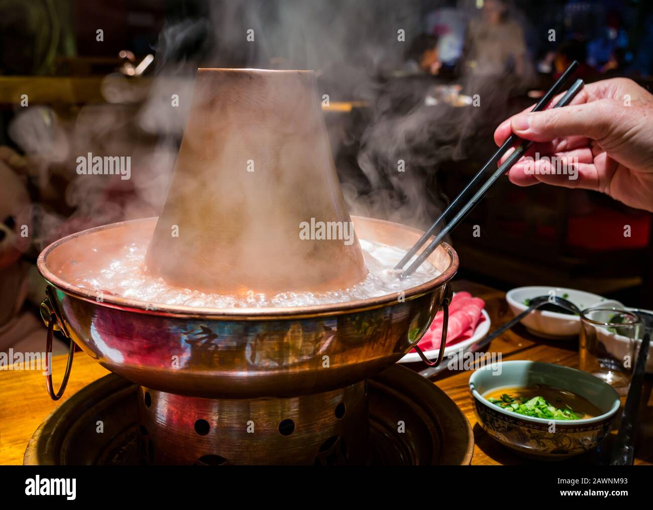 Mongolian hotpot with meat slices served at restaurant table, Xi Cheng Hutong District, Beijing, China, Asia Stock Photo