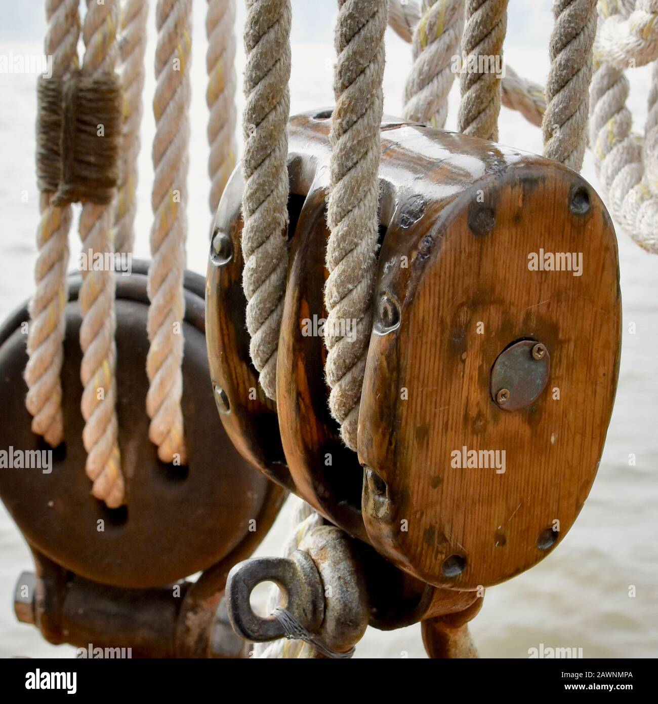 A wooden block and tackle on a historic sailing sloop. Stock Photo