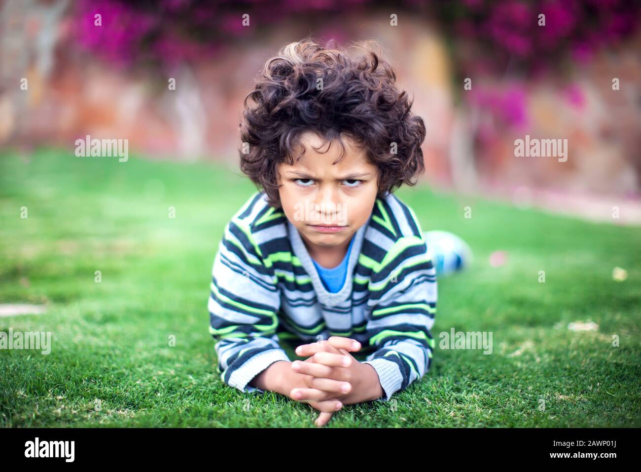 A portrait of sad kid boy looking at camera. Children and emotions concept Stock Photo