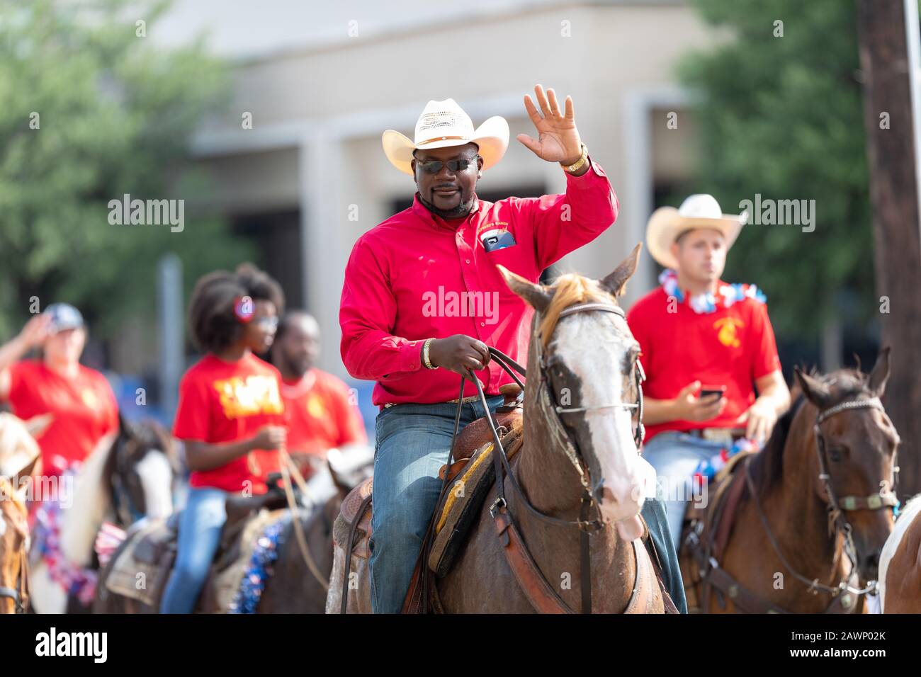 Cowboy waving hat hi-res stock 