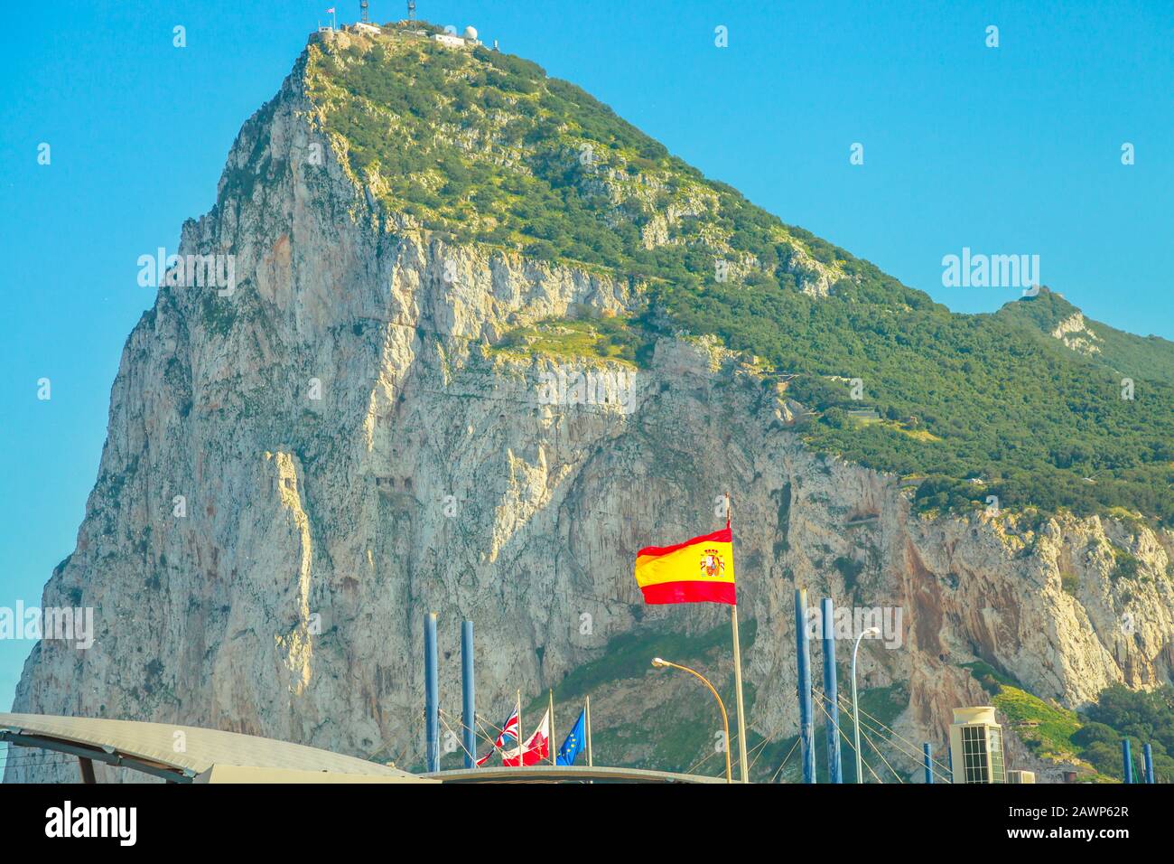 The Gibraltar border, between Spain and England, bay view from Spanish territory in Spain. Flags of Europe, Spain, and the United Kingdom together. Stock Photo