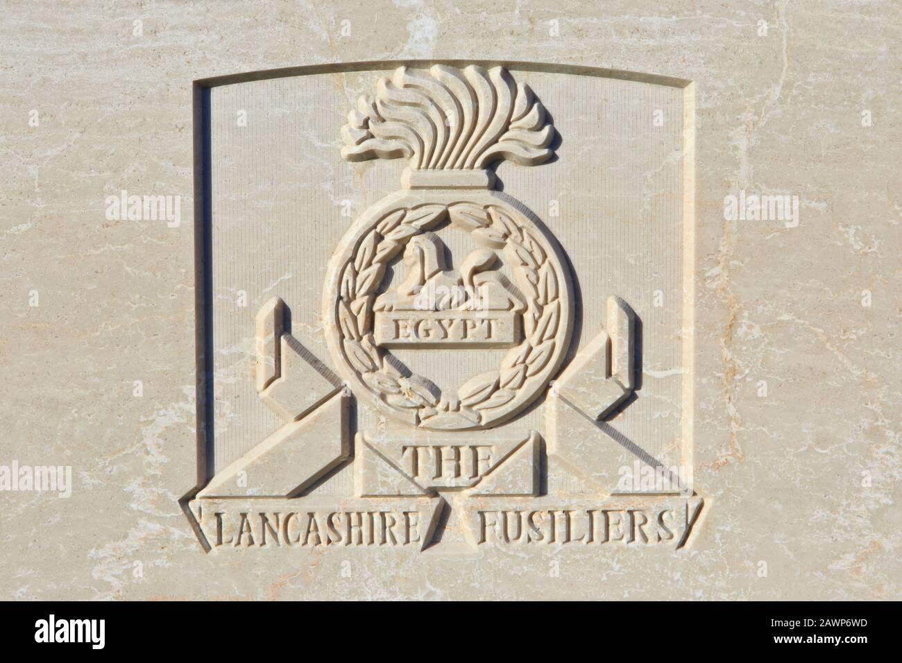 The Lancashire Fusiliers (1688-1968) regimental emblem on a World War I headstone at Tyne Cot Cemetery in Zonnebeke, Belgium Stock Photo