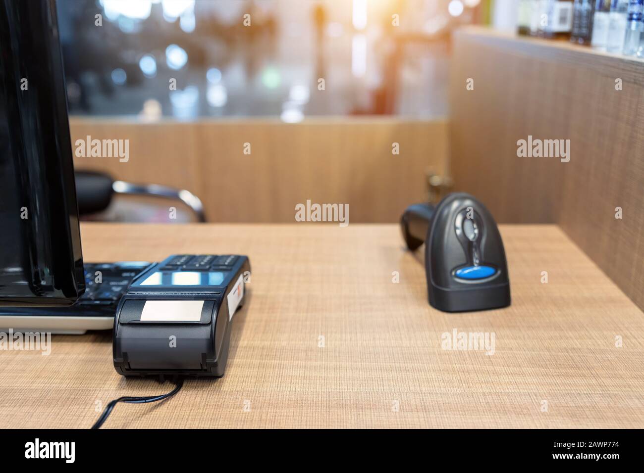 Emty cashier desk counter POS terminal with barcode scanner, receipt