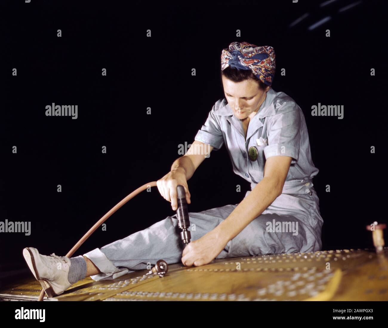 War Production Worker Drilling on a Liberator Bomber, Consolidated Aircraft Corp., Fort Worth, Texas, USA, photograph by Howard R. Hollem, U.S. Office of War Information, October 1942 Stock Photo