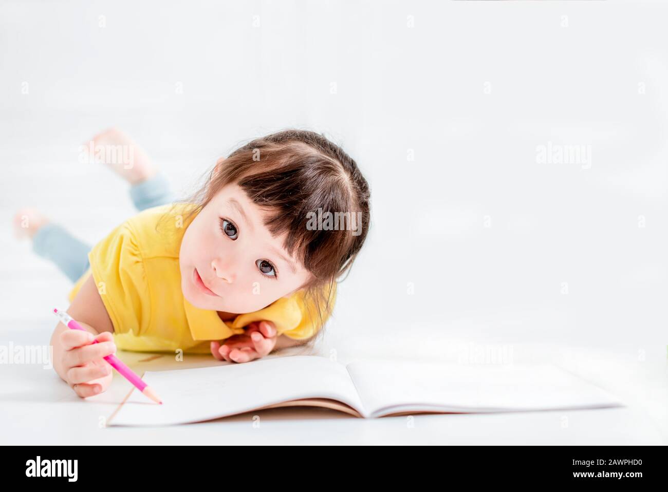 cute beautiful  little girl drawing  on the flloor Stock Photo