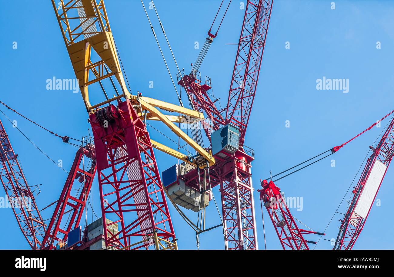 Low angle shot of steel cranes with a clear blue sky Stock Photo - Alamy
