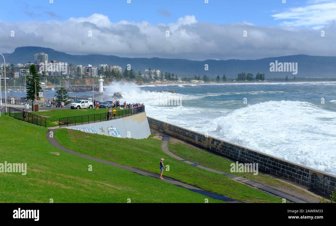 Climate change, from drought, fire to flood. After heavy rain and flooding  in the Illawarra, NSW Australia, people gather to watch the king tide and Stock Photo