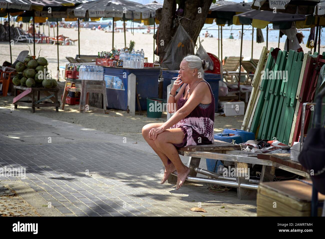 Woman smoking a cigarette outside ; Mature woman smoker Stock Photo