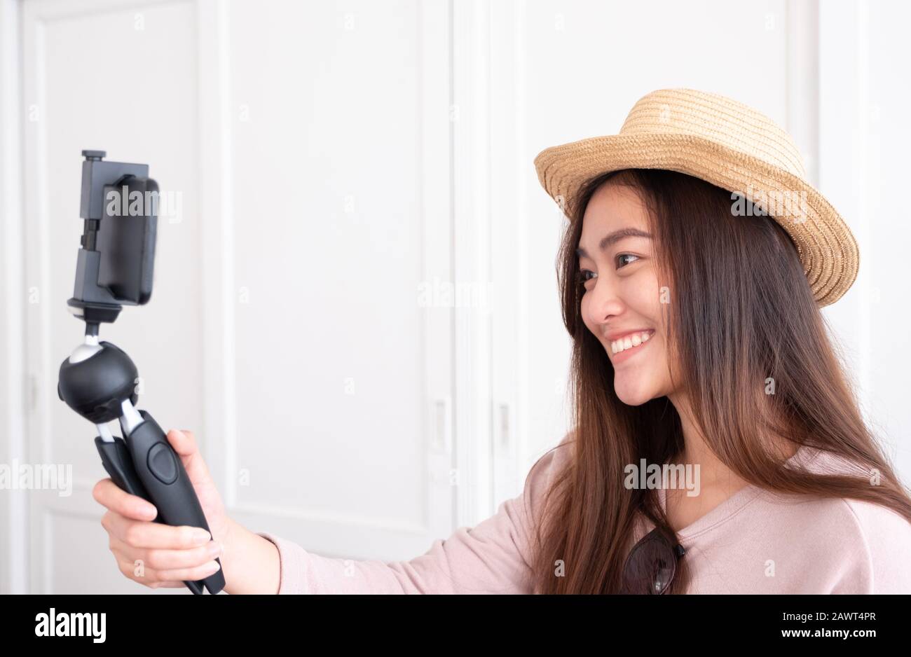 Asian young female blogger recording vlog video with mobile phone live streaming when travel.online influencer on social media viral concept Stock Photo