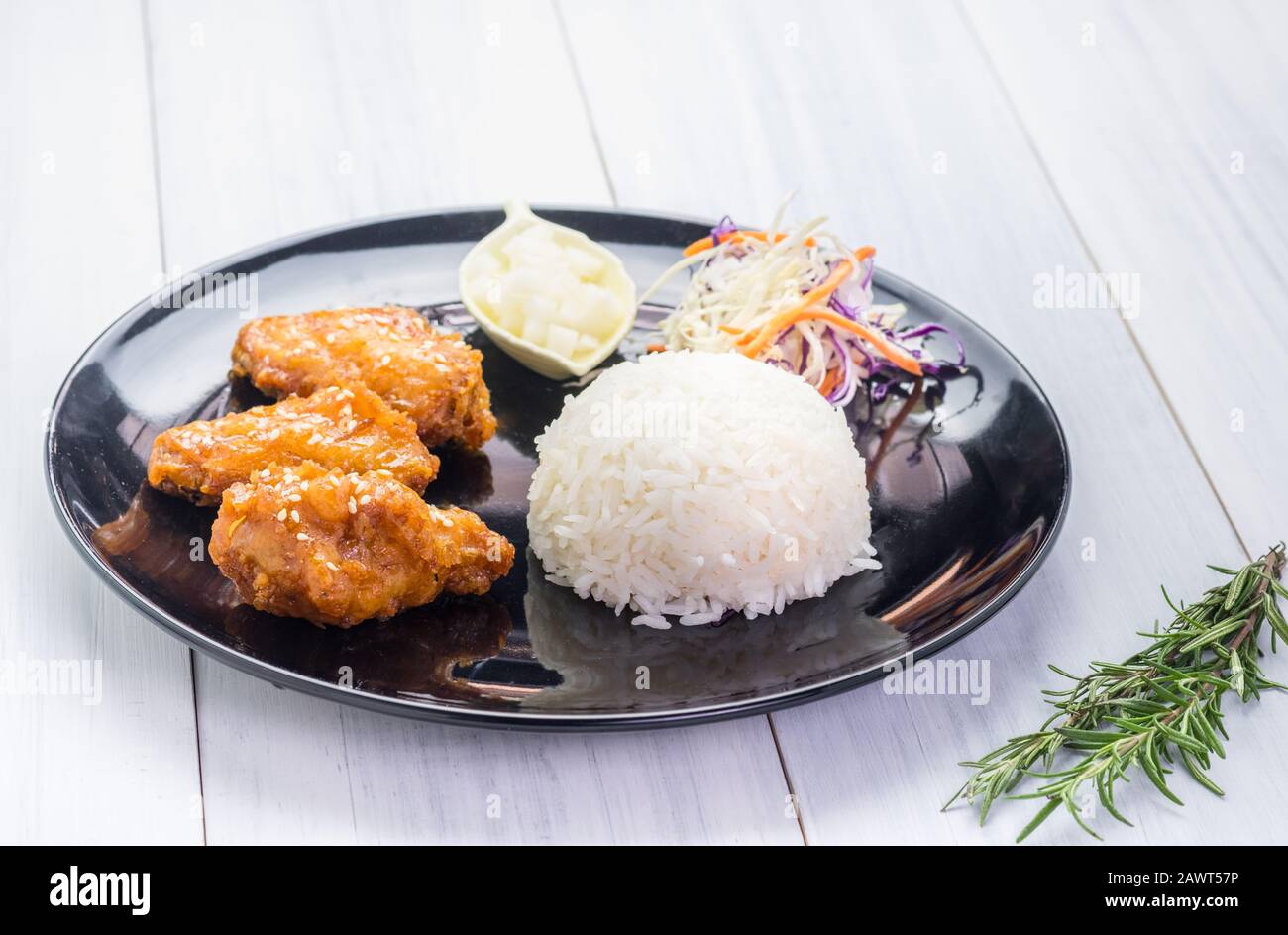 rice,fried chicken wing and salad on tablecloth on white wood table in kitchen,food menu meal. Stock Photo