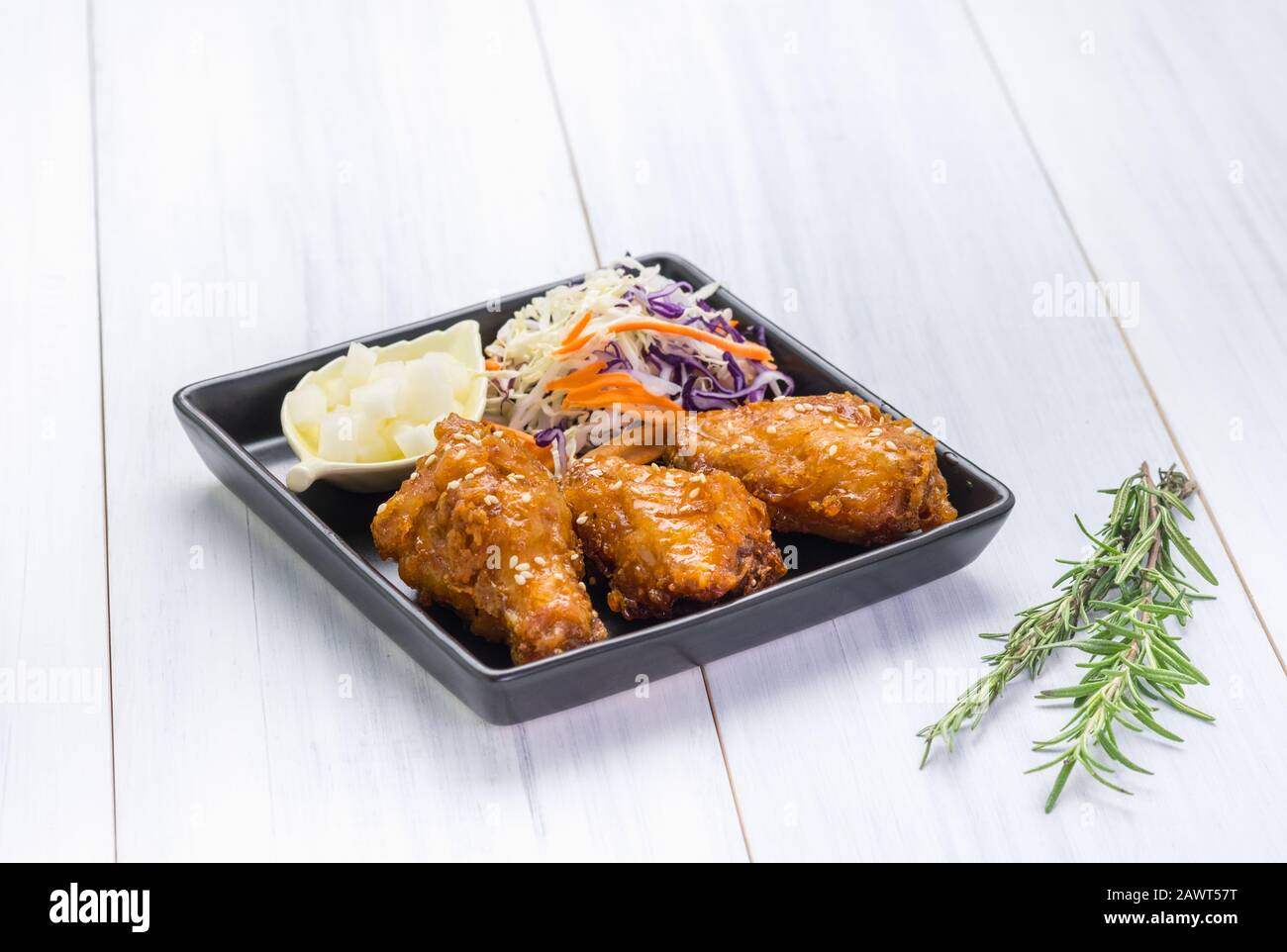 fried chicken wing and salad on tablecloth on white wood table in kitchen,food menu appetizer. Stock Photo