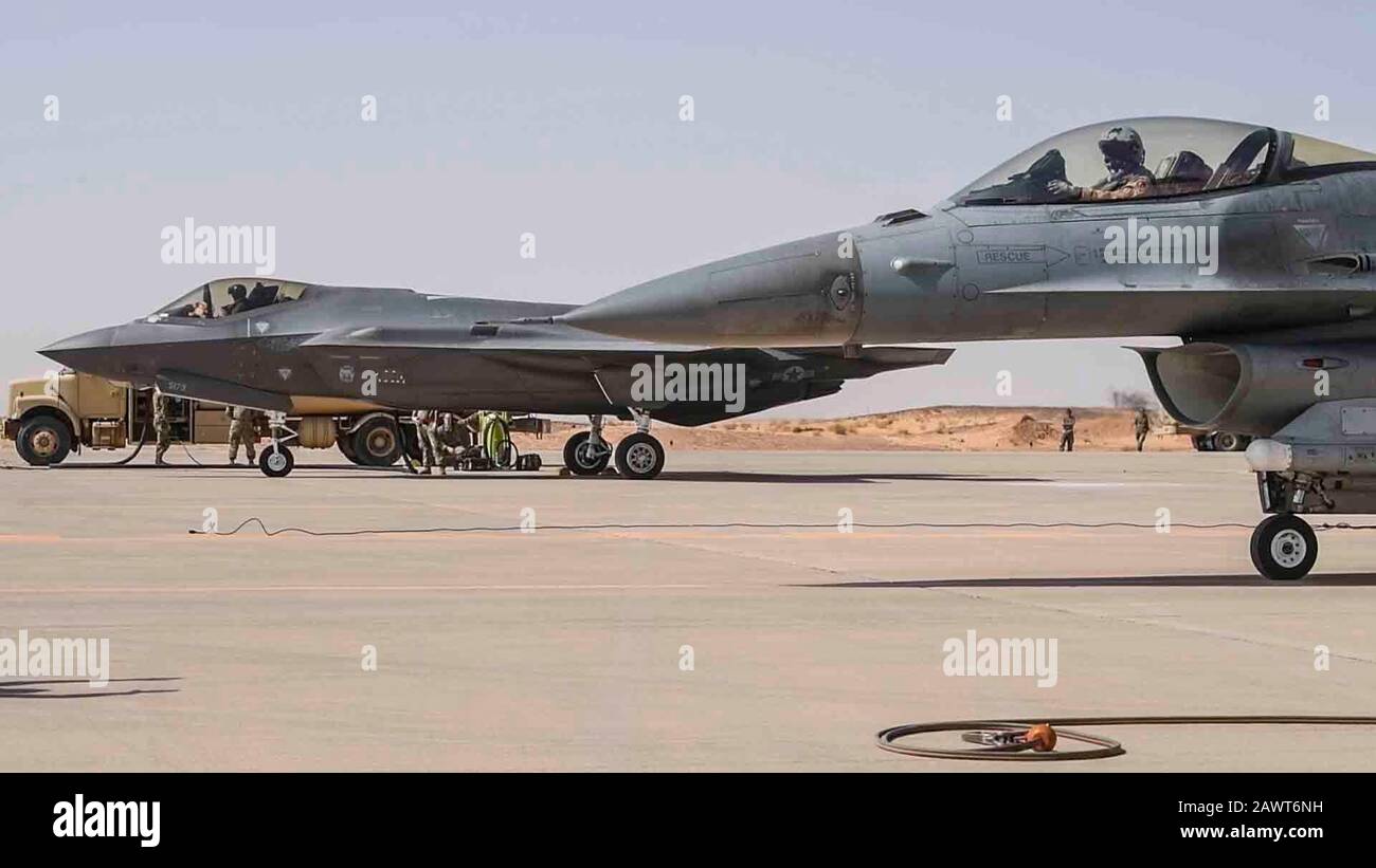 A U.S. Air Force F-35A Lightning II and an F-16 Fighting Falcon park on the flight line during an engine-running refueling at Prince Sultan Air Base, Kingdom of Saudi Arabia, Feb. 7, 2020. Airmen at PSAB executed hot refueling capabilities by generating easily accessible fuel and rapidly returning the diverse aircraft set to the skies as part of an agile combat employment mission that exercised a critical capability of U.S. Air Forces Central Command. (U.S. Air Force photo by Senior Airman Giovanni Sims) Stock Photo