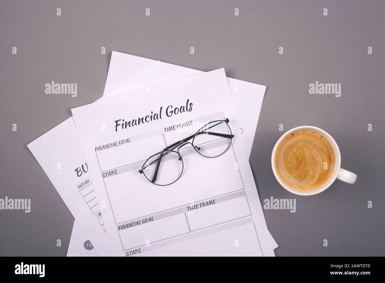 Modern methods of conducting financial accounting and education of financial discipline. Printouts to control accumulations on a gray desktop. Background with copy space. Stock Photo