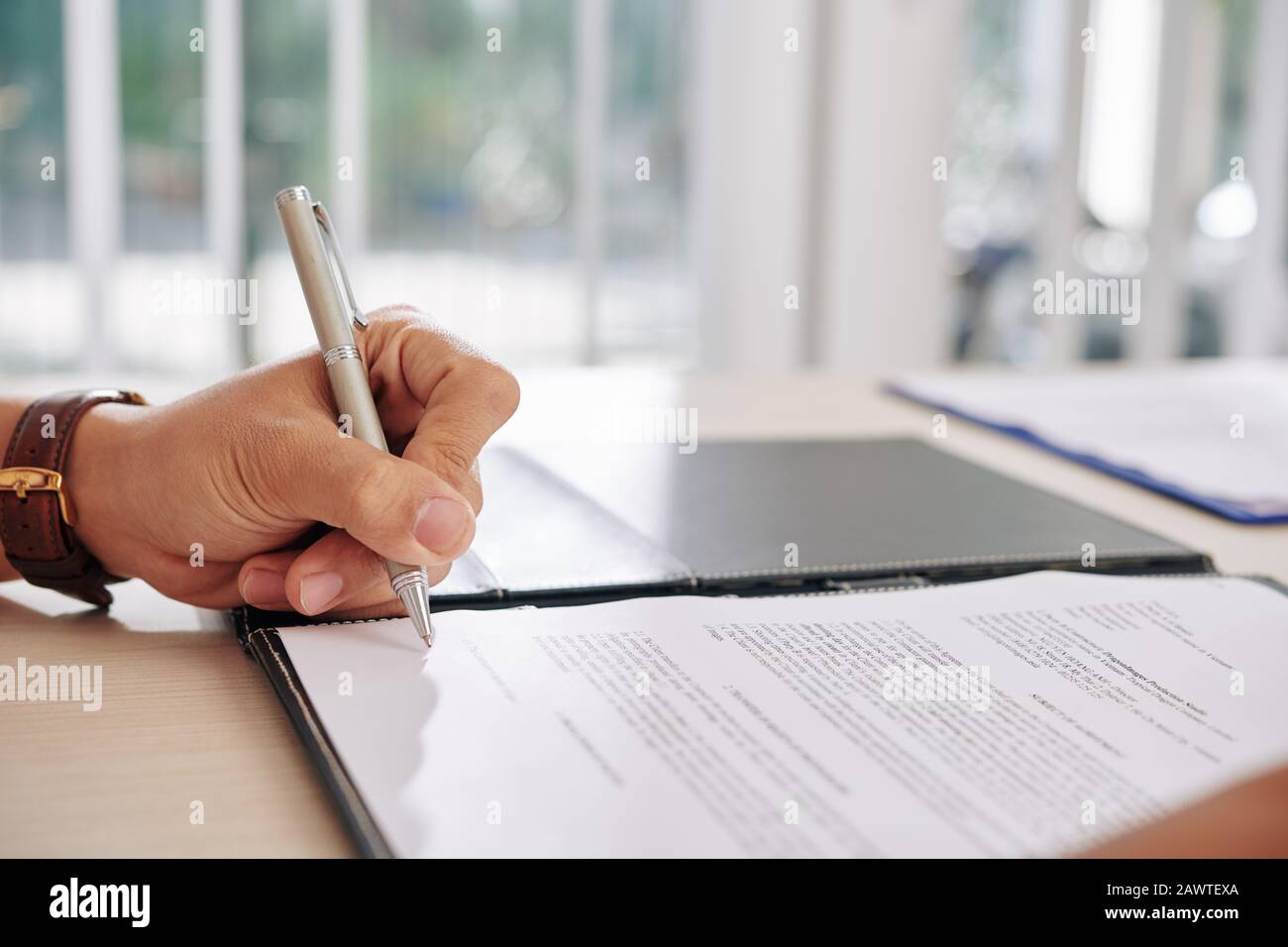 Hand of business person signing contract at desk in office Stock Photo ...
