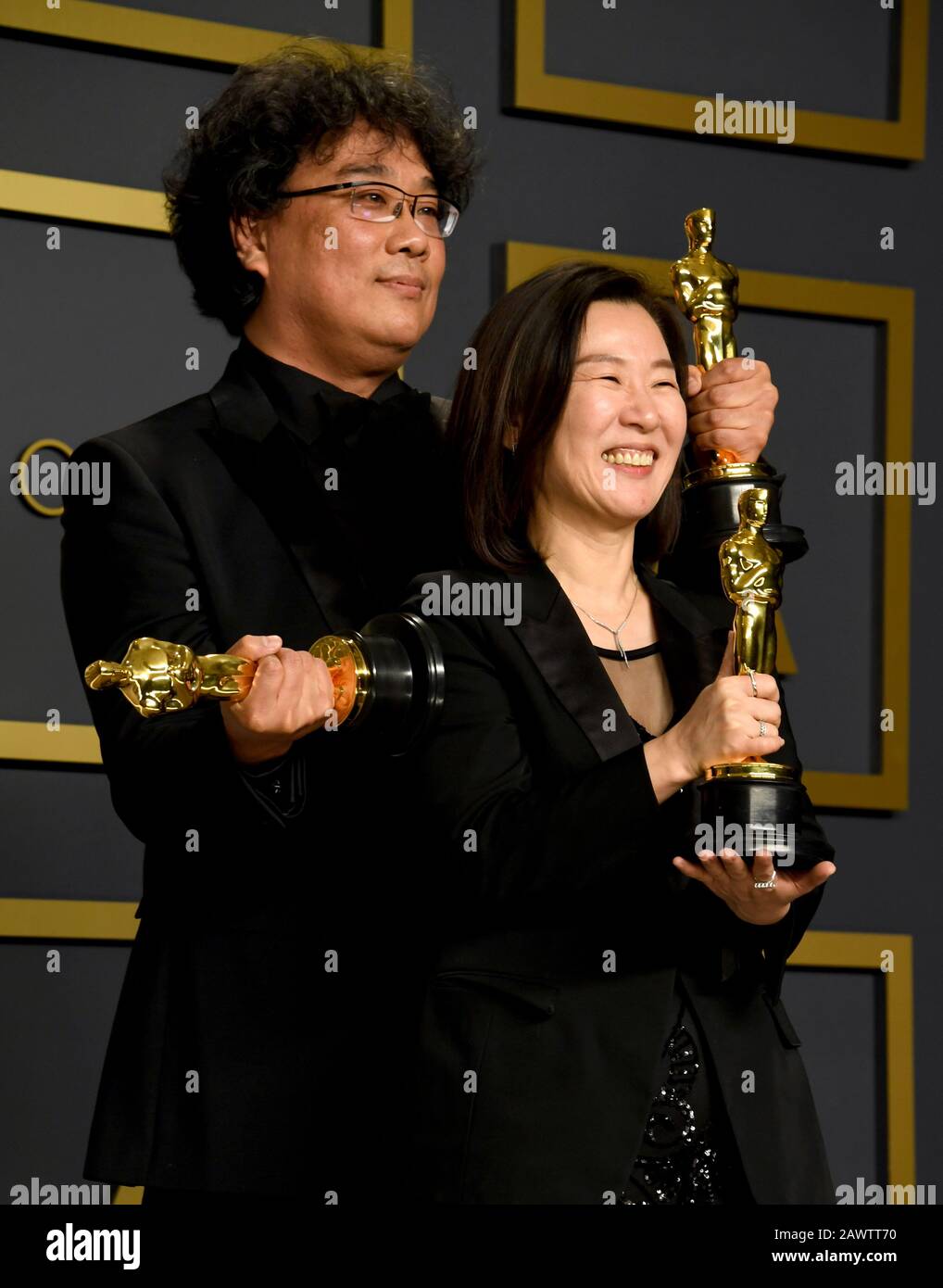 Bong Joon-ho and Kwak Sin-ae with their Oscars for Best Original Screenplay, International Feature Film, Best Director, and Best Picture for Parasite in the press room at the 92nd Academy Awards held at the Dolby Theatre in Hollywood, Los Angeles, USA. Stock Photo