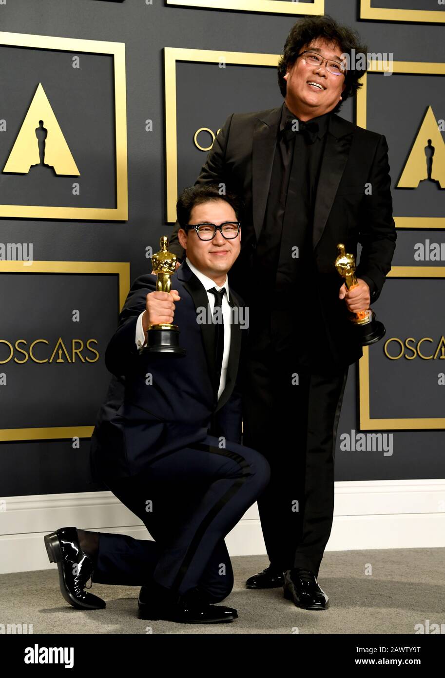 Han Jin-won and Bong Joon-ho with their Oscars for Best Original Screenplay, International Feature Film, Best Director, and Best Picture for Parasite in the press room at the 92nd Academy Awards held at the Dolby Theatre in Hollywood, Los Angeles, USA. Stock Photo