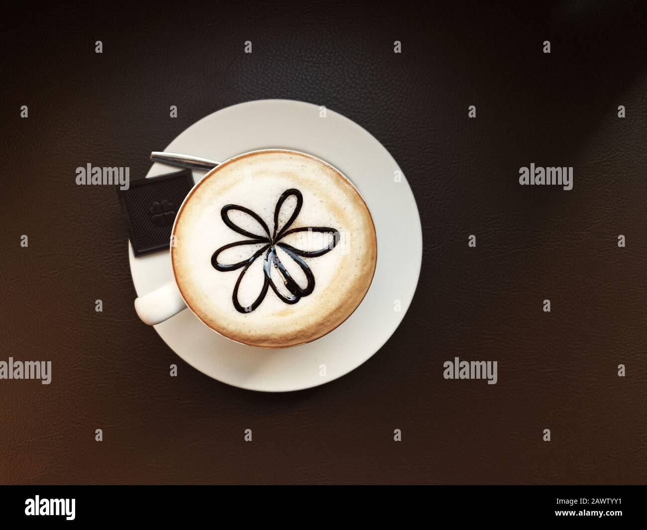 A cup coffee with flower shape in a cafe Stock Photo