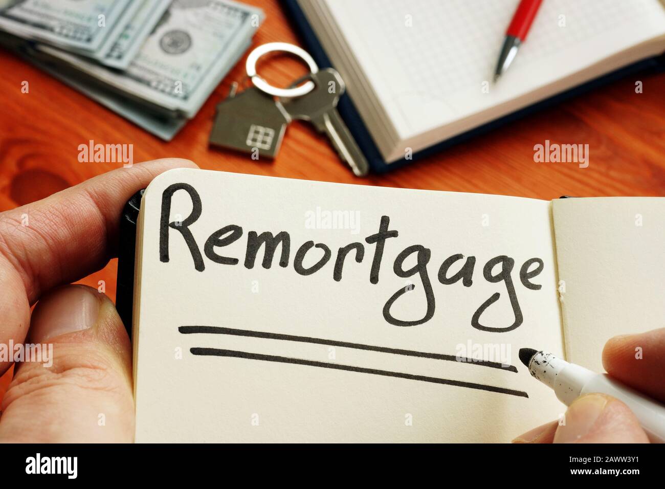 Remortgage handwritten word by man. Stock Photo