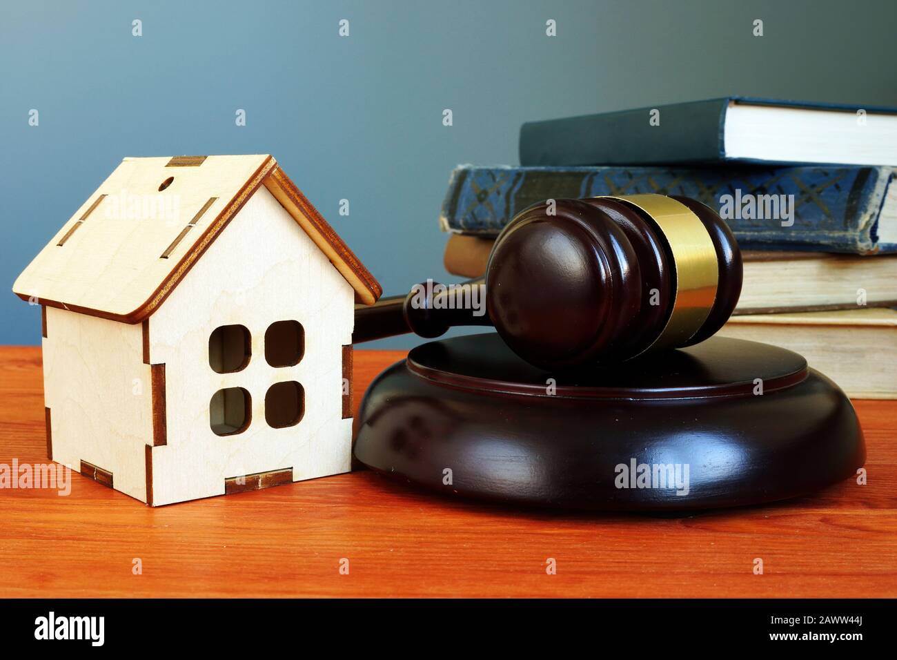 Property law concept. Gavel and tiny home on the desk. Stock Photo