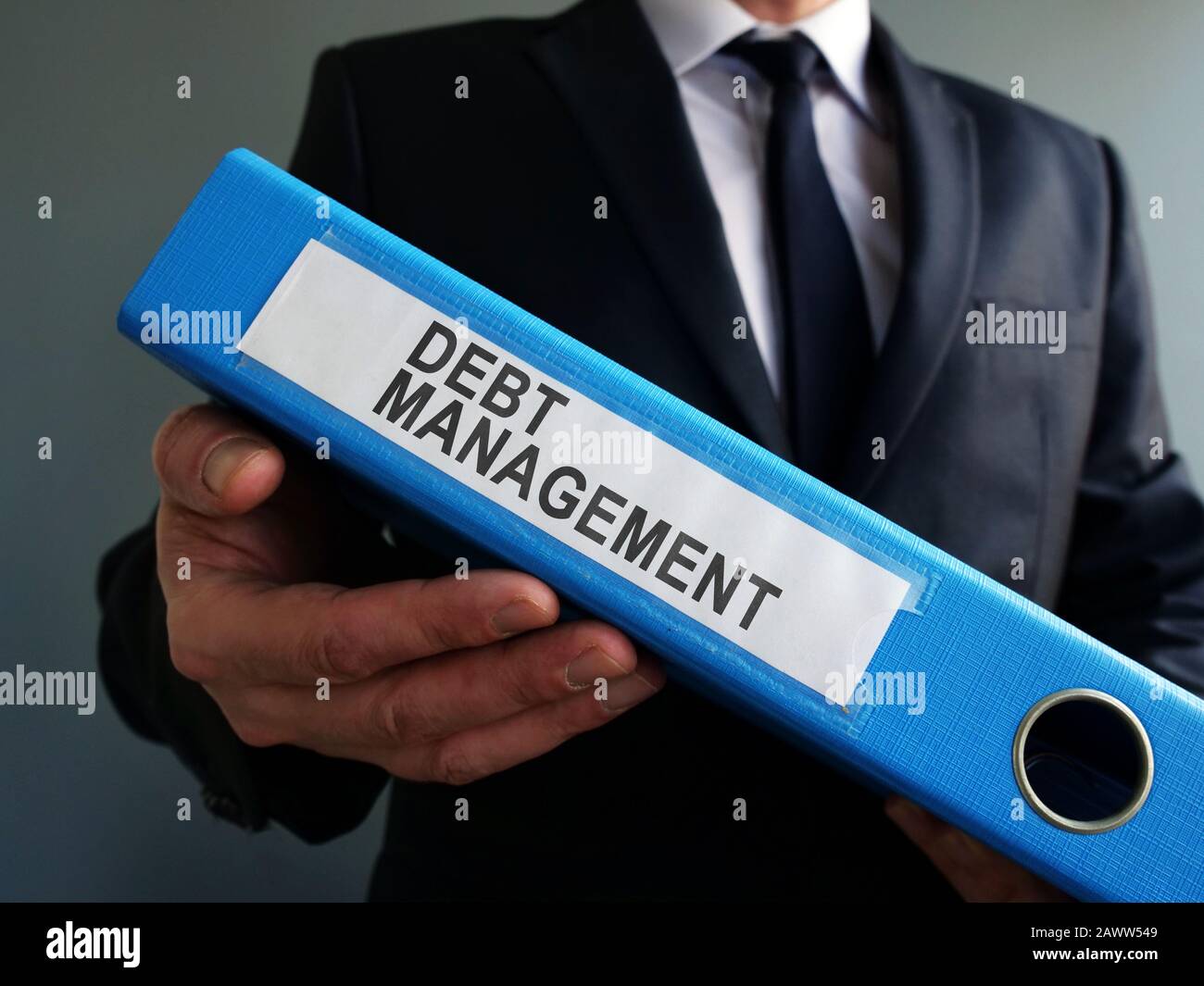 Man and Debt Management papers in the blue folder. Stock Photo