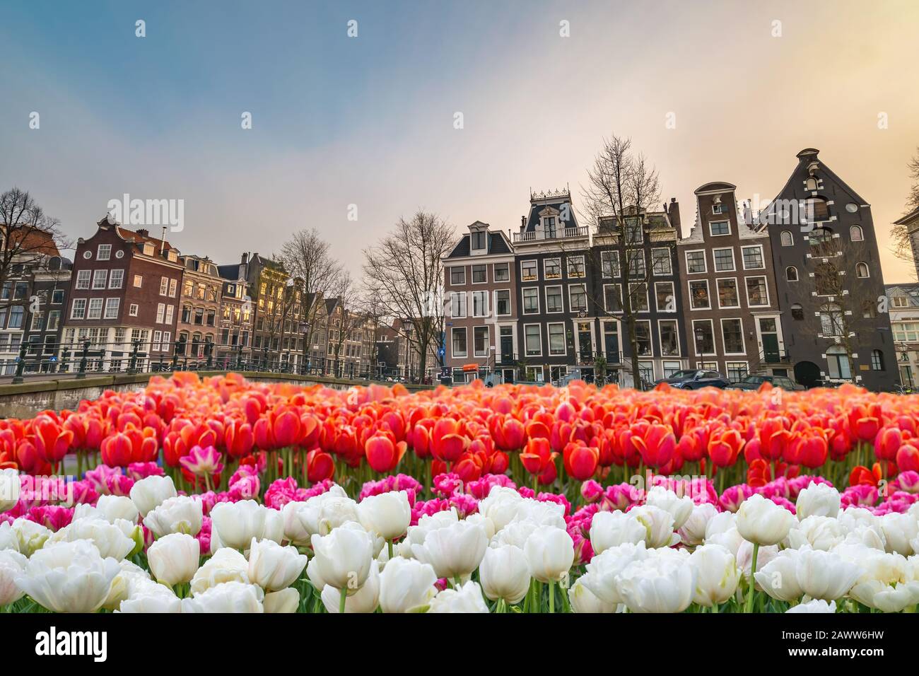 Amsterdam Netherlands, city skyline at canal waterfront and bridge with