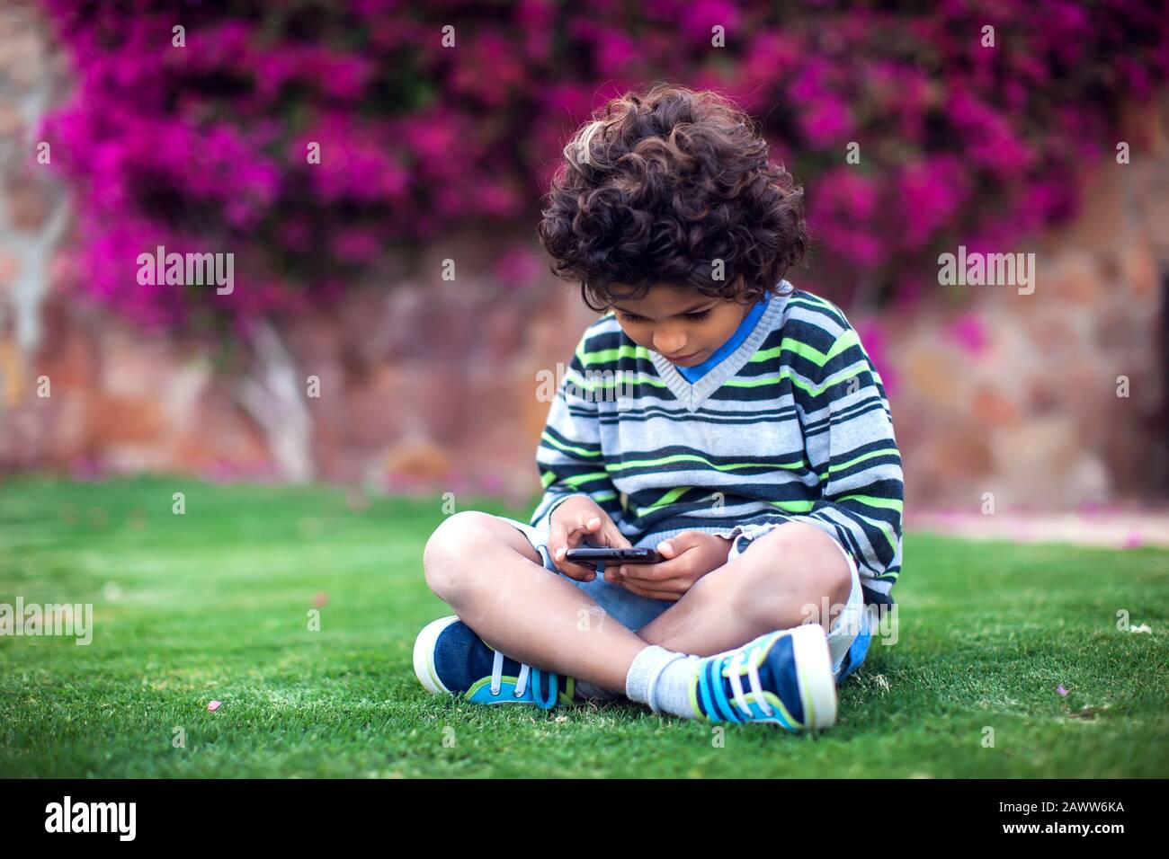 Kid boy playing games on tablet outdoor. Children, technology and