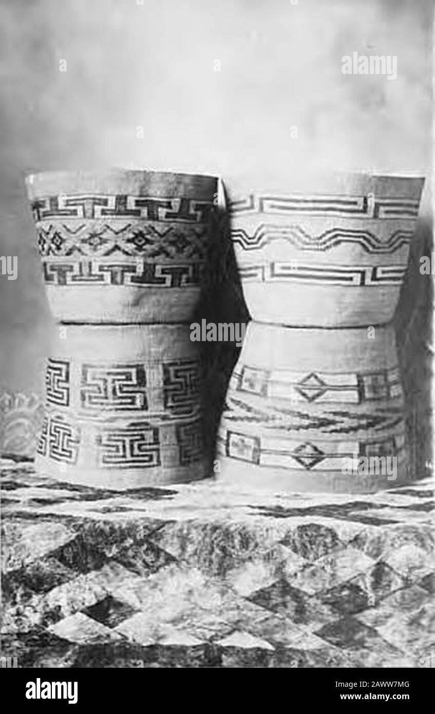 Four large Tlingit spruce root baskets displayed on fur-covered table circa 1910 (AL+CA 4815). Stock Photo