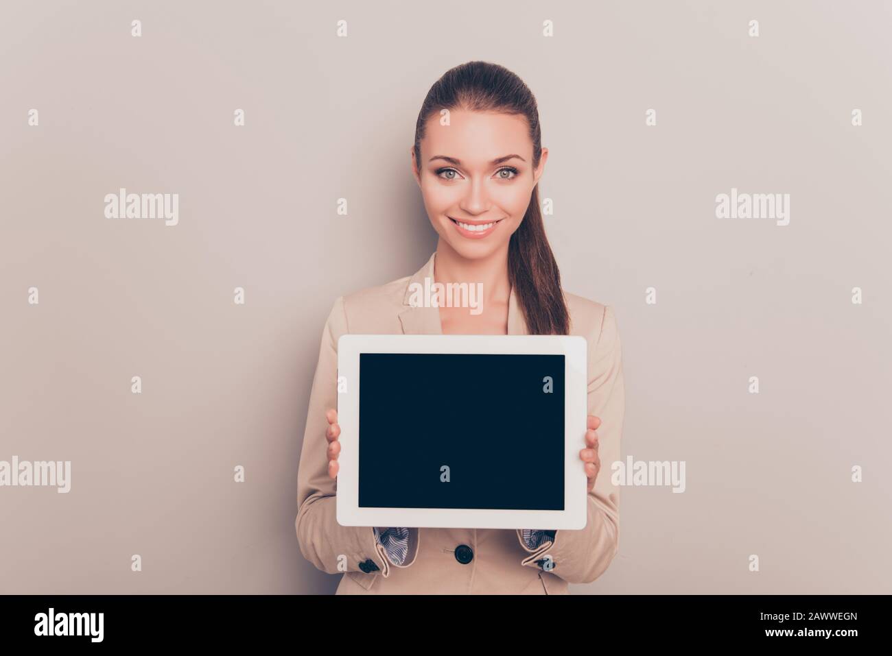 Pretty smiling woman showing black screen of digital tablet Stock Photo ...