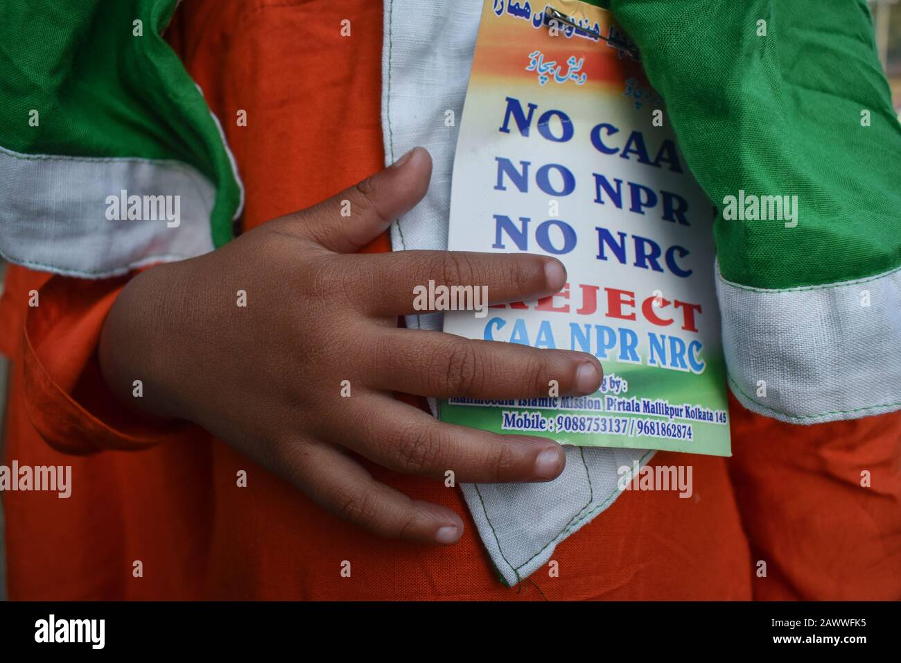 A little girl shows her Batch on a Protest rally against NRC and CAA in Kolkata, India. Stock Photo