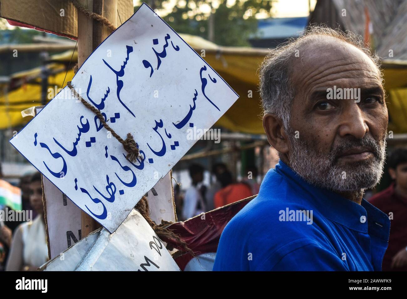 A man is standing beside of an Urdu banner on an NRC protest programme in Kolkata, India. Stock Photo