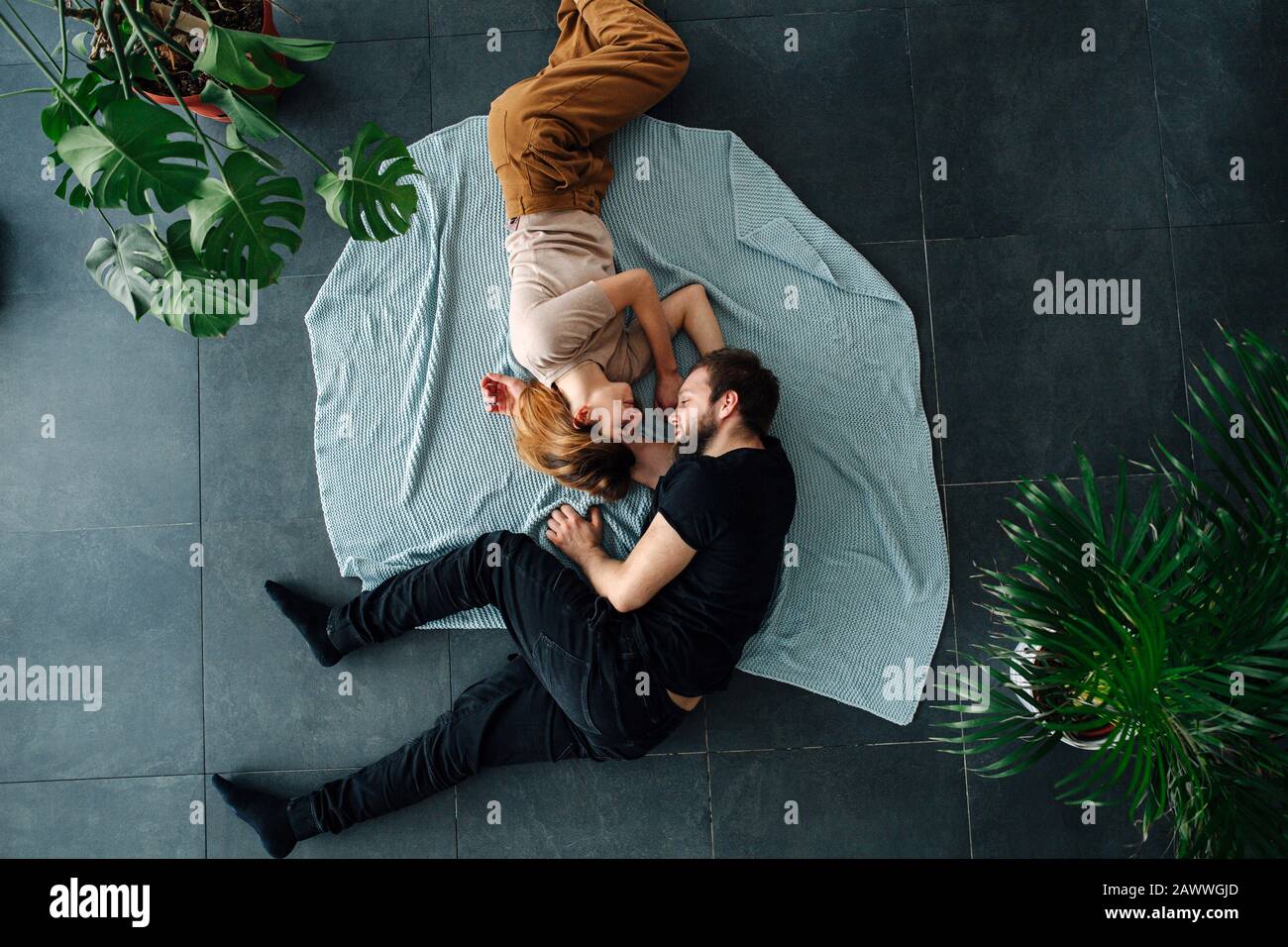 Two People In Love Lying On A Floor Face To Face Curled Stock