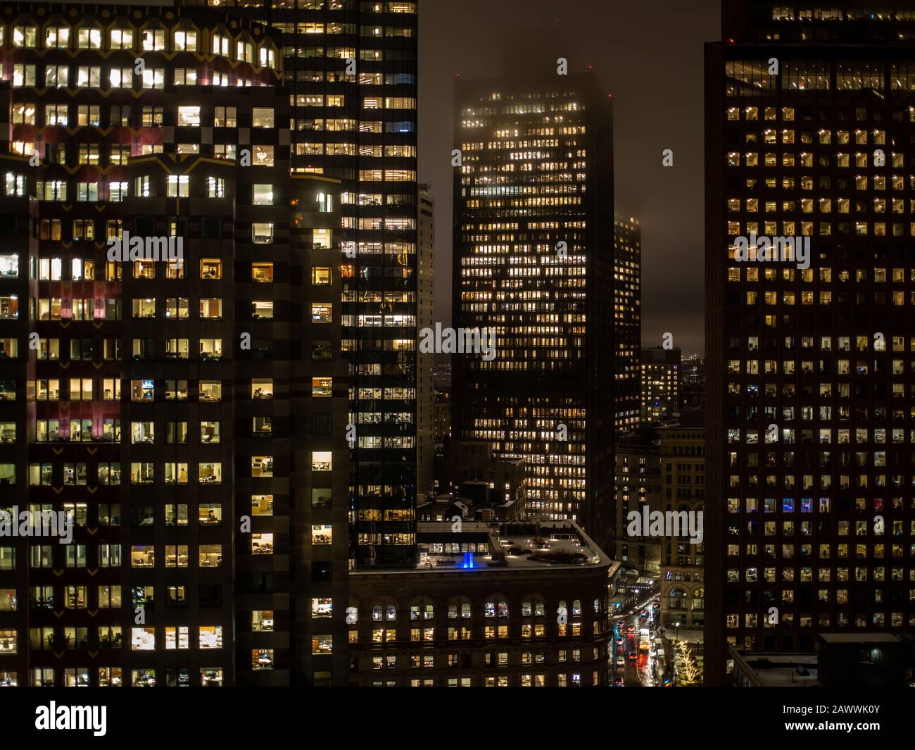 Boston Massachusetts, December 17, 2019: Lights In The Windows Of Office Towers At Night Stock Photo