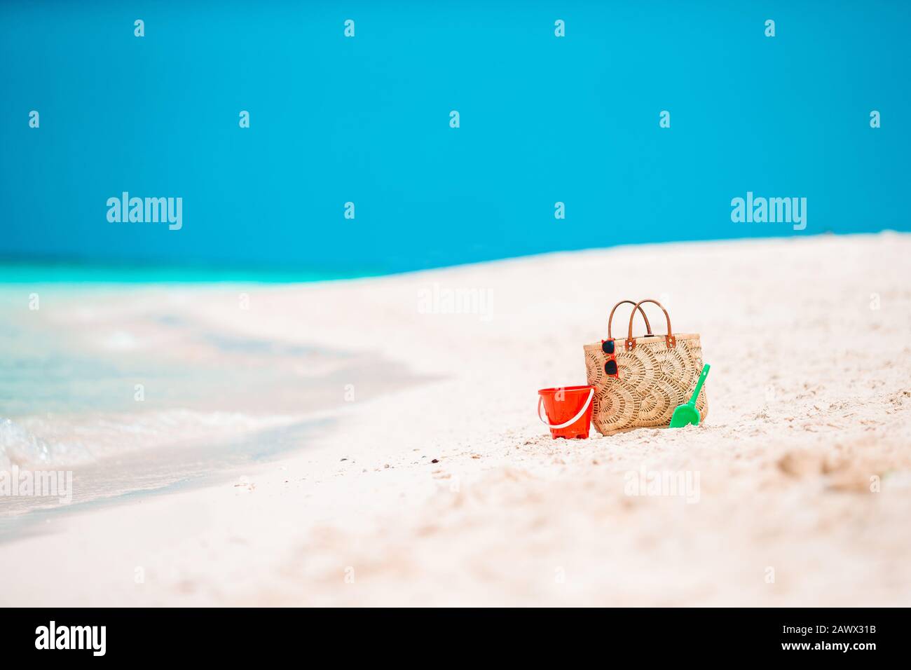 Beach accessories straw bag, hat and unglasses on the beach Stock