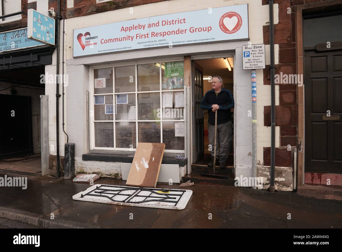 Keith Bainbridge, 66, a volunteer for North West Ambulance Service, cleans up the Appleby and District Community First Responder Group premises in Appleby-in-Westmorland, Cumbria, in the aftermath of Storm Ciara which lashed the country Sunday. Stock Photo