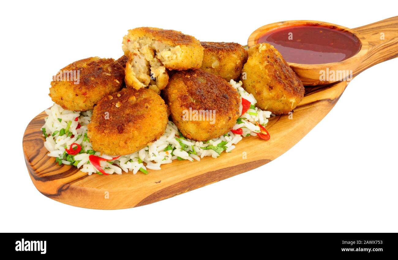 Prawn fish cakes with rice and chilli sauce dip on an olive wood