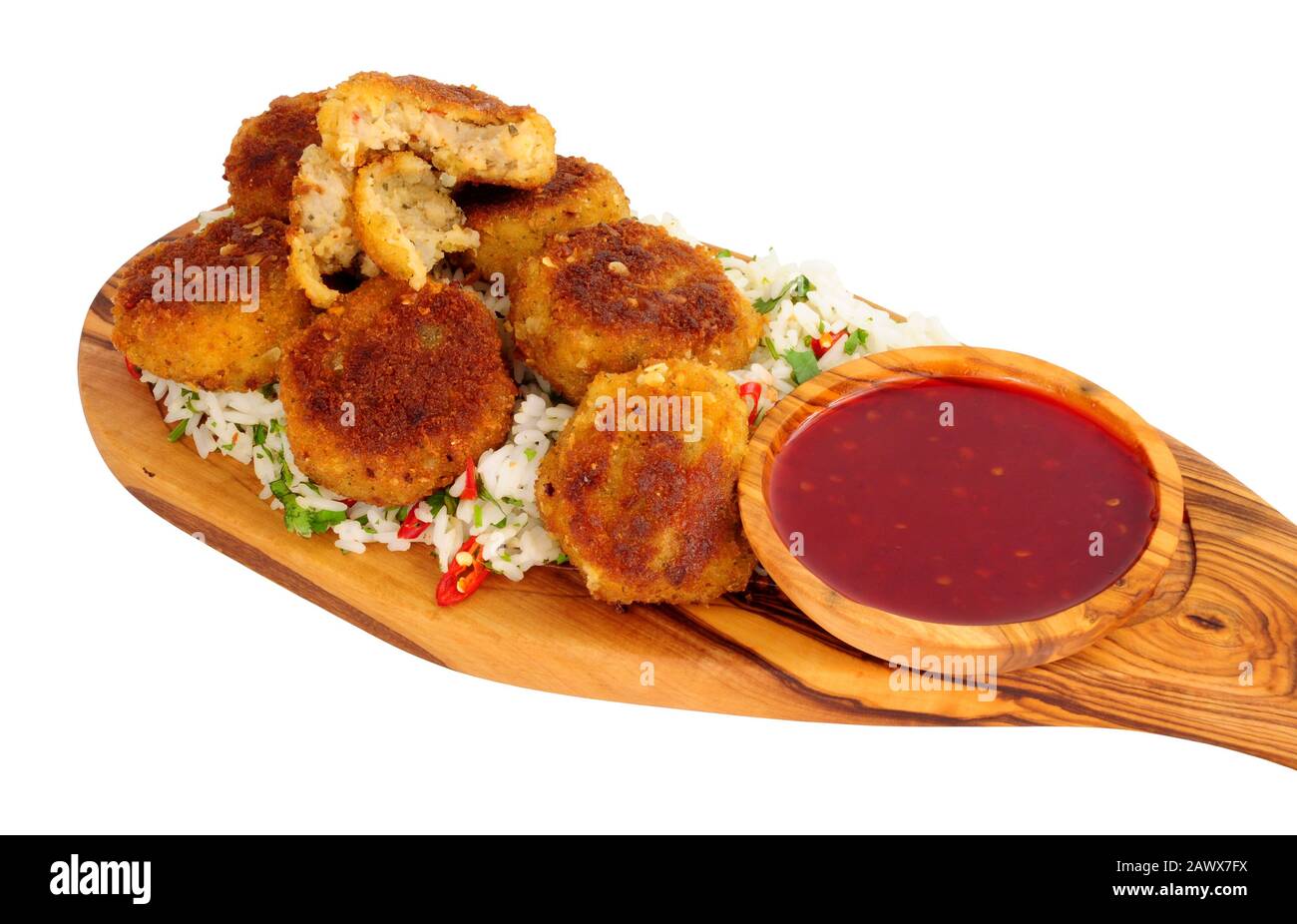 Prawn fish cakes with rice and chilli sauce dip on an olive wood