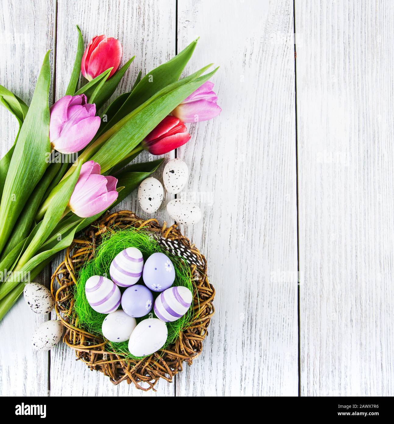 easter background with eggs in nest and pink tulips Stock Photo - Alamy