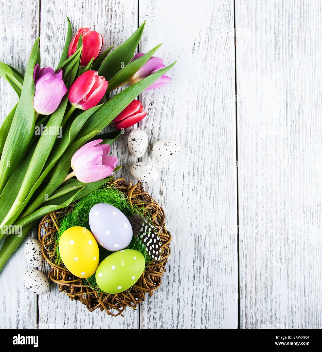 easter background with eggs in nest and pink tulips Stock Photo - Alamy