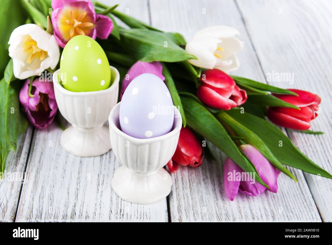 Easter eggs and tulips on a wooden table Stock Photo - Alamy